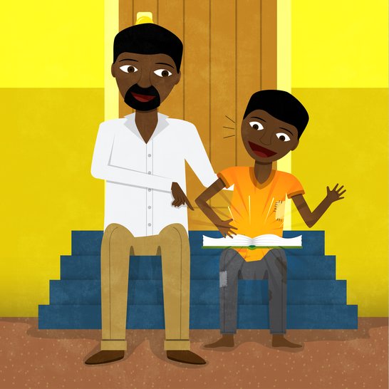 A man sitting next to a boy reading a book.